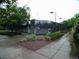 Fenced tennis court with gate, surrounded by greenery and a paved sidewalk at 877 Eldorado Dr, Superior, CO 80027