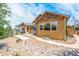 House with backyard patio, landscaping, and a gravel yard at 3995 Manorbrier Cir, Castle Rock, CO 80104