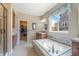 Bathroom with a soaking tub, shower, and double vanity at 3995 Manorbrier Cir, Castle Rock, CO 80104