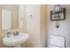 Small bathroom with pedestal sink and toilet at 3995 Manorbrier Cir, Castle Rock, CO 80104