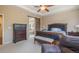 Bright bedroom with a king-size bed and ensuite bathroom access at 3995 Manorbrier Cir, Castle Rock, CO 80104