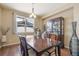 Formal dining room with wood table, six chairs, and window view at 3995 Manorbrier Cir, Castle Rock, CO 80104