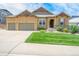 Two-story house with a three-car garage and landscaped front yard at 3995 Manorbrier Cir, Castle Rock, CO 80104