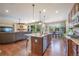 Open concept kitchen with island, hardwood floors, and stainless steel appliances at 3995 Manorbrier Cir, Castle Rock, CO 80104