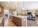Open concept kitchen with island and hardwood floors at 3995 Manorbrier Cir, Castle Rock, CO 80104