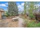 Backyard with a large tree, patio area, seating and fenced perimeter for privacy at 2166 S Joplin Way, Aurora, CO 80013