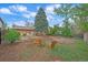 Expansive backyard with lawn, mature trees, and seating, ideal for outdoor enjoyment at 2166 S Joplin Way, Aurora, CO 80013