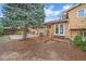Backyard showing brick stairs up to door, tall tree, lawn and fenced perimeter at 2166 S Joplin Way, Aurora, CO 80013