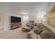 Spacious basement living room featuring plush seating, fireplace, and large television at 2166 S Joplin Way, Aurora, CO 80013