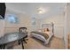 Simple bedroom setup with bed, small windows, chair and small table at 2166 S Joplin Way, Aurora, CO 80013