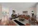 Bright living room with hardwood floors, stylish furnishings, and modern decor and open doorway to the kitchen at 2166 S Joplin Way, Aurora, CO 80013