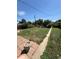 Spacious backyard with a narrow concrete walkway and a shed at 460 Yates St, Denver, CO 80204