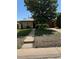 Modest home with mature trees and a red garage door at 460 Yates St, Denver, CO 80204