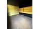 Room with painted black ceiling and yellow accent wall featuring built-in shelving at 460 Yates St, Denver, CO 80204