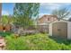 Image of the backyard featuring a storage shed and garden area with green grass at 943 Pinon Ct, Longmont, CO 80504