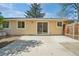 Home exterior showcasing a fenced backyard with sliding glass doors leading to a concrete patio at 943 Pinon Ct, Longmont, CO 80504