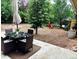 Tranquil backyard featuring outdoor furniture, a fire pit, and mature trees at 943 Pinon Ct, Longmont, CO 80504