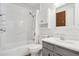 Clean bathroom with a shower-tub combo, and a vanity with a framed mirror at 943 Pinon Ct, Longmont, CO 80504