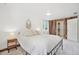 Cozy bedroom featuring a queen bed, decorative mirror, and unique wooden wall panel at 943 Pinon Ct, Longmont, CO 80504