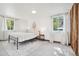 Sun-filled bedroom with neutral carpet, a queen bed, and bright windows at 943 Pinon Ct, Longmont, CO 80504