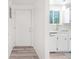 Bright entryway and kitchen area with white cabinets and modern appliances at 943 Pinon Ct, Longmont, CO 80504