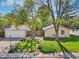 Well-maintained front yard with lush greenery, detached garage, and inviting exterior at 943 Pinon Ct, Longmont, CO 80504