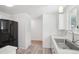 Bright kitchen featuring a stainless steel sink, black refrigerator, and wood flooring at 943 Pinon Ct, Longmont, CO 80504