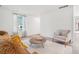 Bright living area with large windows, wood floors, and comfortable furnishings at 943 Pinon Ct, Longmont, CO 80504