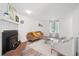 Cozy living room with fireplace, wood floors, and bright natural light at 943 Pinon Ct, Longmont, CO 80504