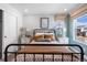 This bedroom features two large windows with views and neutral walls and modern bedside tables at 16648 W 92Nd Pl, Arvada, CO 80007