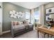 Light filled bedroom with daybed, desk area, and unique wall decor creates a cozy and stylish space at 16648 W 92Nd Pl, Arvada, CO 80007