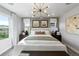 This bedroom features two large windows and neutral walls with an elegant ceiling light fixture at 16648 W 92Nd Pl, Arvada, CO 80007