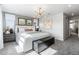 This bedroom features a large plush bed with a decorative accent wall and plenty of natural light at 16648 W 92Nd Pl, Arvada, CO 80007