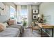 Inviting bedroom features a gray daybed, a modern desk area, and stylish decorations at 16648 W 92Nd Pl, Arvada, CO 80007