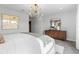This bedroom features a large plush bed, neutral walls and is brightly lit with an elegant light fixture at 16648 W 92Nd Pl, Arvada, CO 80007