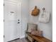 Cozy entryway with a wooden bench, decorative pillows, and stylish bags, creating a welcoming first impression at 16648 W 92Nd Pl, Arvada, CO 80007