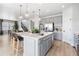 Open-concept kitchen with large island, stainless appliances, and dining area views at 16648 W 92Nd Pl, Arvada, CO 80007