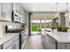 Modern kitchen with stainless steel appliances and a view to the backyard through sliding glass doors at 16648 W 92Nd Pl, Arvada, CO 80007