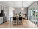 Modern kitchen featuring a large center island with seating and stylish pendant lighting at 16648 W 92Nd Pl, Arvada, CO 80007