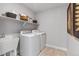 Efficient laundry room with modern washer, dryer, sink, and ample shelving at 16648 W 92Nd Pl, Arvada, CO 80007