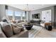 Stylish living room featuring large windows, modern furnishings, and elegant lighting at 16648 W 92Nd Pl, Arvada, CO 80007