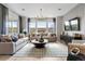 Bright living room with large windows, comfortable seating, and modern decor at 16648 W 92Nd Pl, Arvada, CO 80007