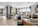 Open-concept living area with hardwood floors, natural light, and comfortable sofas at 16648 W 92Nd Pl, Arvada, CO 80007