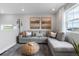 Relaxing living room with a gray sectional, textured wallpaper, and plentiful natural light at 16648 W 92Nd Pl, Arvada, CO 80007
