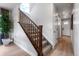 Carpeted staircase with wooden railing and abundant natural light, creating an elegant transition between floors at 16648 W 92Nd Pl, Arvada, CO 80007