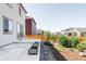 Backyard featuring a patio, stepping stone path, and garden beds, surrounded by wood fencing at 6117 Easton Cir, Frederick, CO 80504