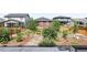 A wide view of a backyard featuring several landscaped areas surrounded by neighboring homes and wooden fencing at 6117 Easton Cir, Frederick, CO 80504