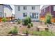 A backyard with a variety of small bushes and a stone pathway leading to a bench at 6117 Easton Cir, Frederick, CO 80504