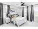 Comfortable bedroom featuring a king bed, nightstands, soft gray decor, and a ceiling fan at 6117 Easton Cir, Frederick, CO 80504