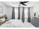 Bedroom with a king bed, a ceiling fan, neutral decor, and a window view at 6117 Easton Cir, Frederick, CO 80504